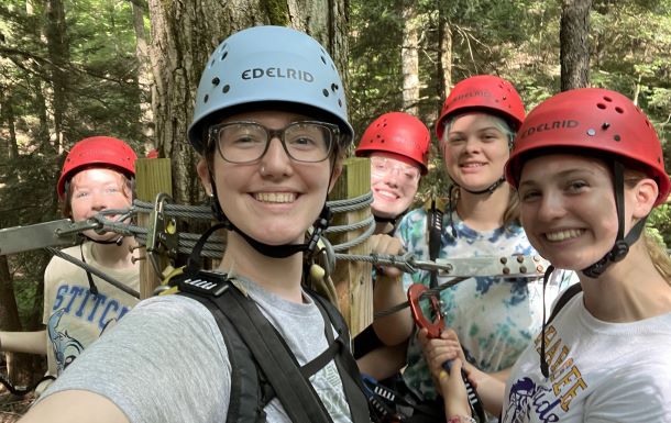 camp staff on a zipline stand